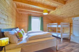 a bedroom with two bunk beds in a wooden cabin at Chalet Seven - by Alpen Apartments in Zell am See