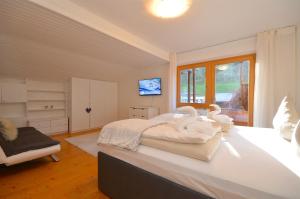a bedroom with a large bed with swans on it at Haus Thumersbach - by Alpen Apartments in Zell am See