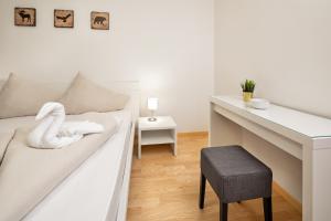 Łóżko lub łóżka w pokoju w obiekcie Mozart Top 2 - by Alpen Apartments