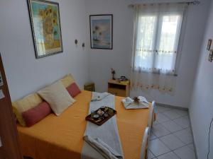 a bedroom with a bed and a table with a tray on it at I Girasoli in Tortol&igrave;