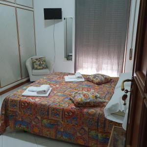 a bedroom with a bed with two towels on it at Alba central City in Palermo