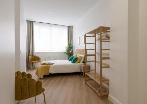 a bedroom with a bed and a bunk ladder at KAIXO BILBAO APARTMENTS in Bilbao