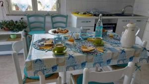 トルトリにあるI Girasoliの青白のテーブルクロスと食べ物が付いたテーブル