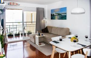 a living room with a couch and a table at Stunning Apartment In Mlaga With 3 Bedrooms, Wifi And Outdoor Swimming Pool in Rincón de la Victoria