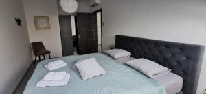 a bed with two towels and two pillows on it at Apartment Sandy Beach - 1st row at sea in Pješčana Uvala 