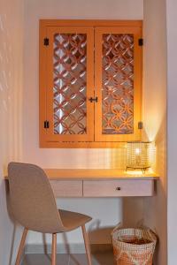 a desk with a chair and a window at Casa Della vita apartment ,Old Town Rhodes in Rhodes Town