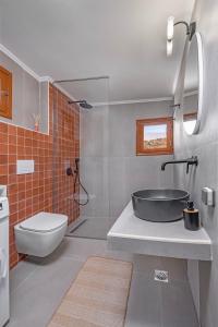 a bathroom with a sink and a toilet and a tub at Casa Della vita apartment ,Old Town Rhodes in Rhodes Town