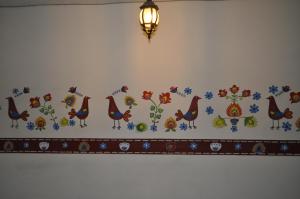 Mia Bonita Hotel Boutique في Tararameo: جدار به زهور وطيور مرسومة عليه