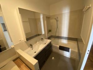 a white bathroom with a sink and a mirror at Beautiful 3BR Apt in Lyon Center in Lyon