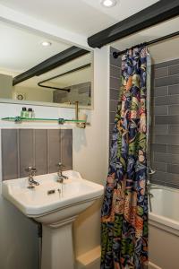 a bathroom with a sink and a shower curtain at The Old Mill in Salisbury