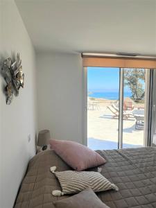 韋基奧港的聖塔露西的住宿－Casa Vecchia，一间卧室配有一张床,享有海滩美景