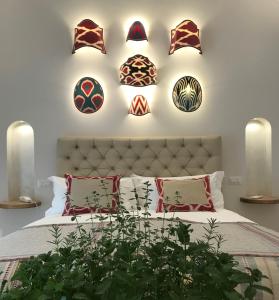 a bedroom with a bed with decorative plates on the wall at Casa Buonocore in Positano