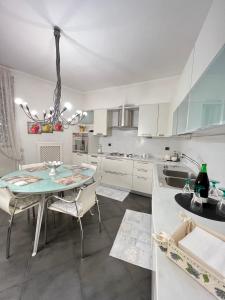 a kitchen with a table and chairs in a kitchen at Casa Vacanze Maridy in Naples