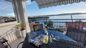 einen blauen Tisch auf einem Balkon mit Blick auf das Wasser in der Unterkunft Apartment Kristina in Trogir