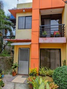 a building with a balcony with plants on it at 2BR 2BT home with pool between Tagbilaran and Panglao in Dauis
