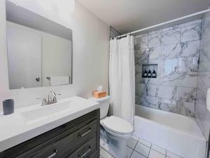 a bathroom with a sink and a toilet and a shower at The Hartford Skyline Downtown Hartford XL Center in Hartford