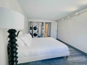 a bedroom with a white bed and a lamp at The Hartford Skyline Downtown Hartford XL Center in Hartford