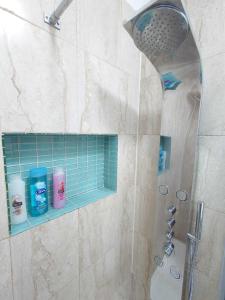 a bathroom with a shower with a blue tile at Kings Cross Apartment in London