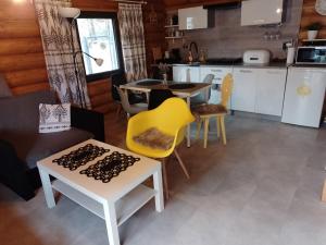 a kitchen and dining room with a table and chairs at Chatka pod lasem in Szczyrk