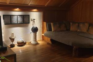 a bedroom with a bed and a lamp on the floor at Ferienwohnung Fam. Biechele in Rückholz