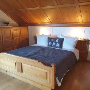 a bedroom with a large bed with blue sheets and pillows at Ferienwohnung Fam. Biechele in Rückholz