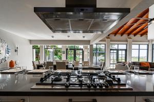 a kitchen with a stove top in a living room at Bird of Paradise Villa in Palm-Eagle Beach