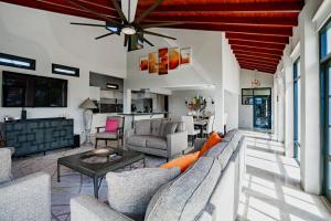 a living room with a couch and a table at Bird of Paradise Villa in Palm-Eagle Beach