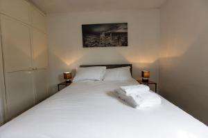 a bedroom with a large white bed with two pillows at Cul-de-sac Creations in Shrewsbury