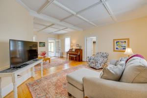 a living room with a couch and a flat screen tv at Country Getaway in Kinsale Sunroom, Pond Access! in Kinsale