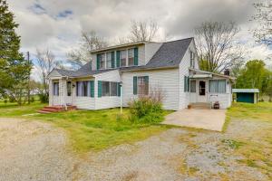 a white house with green shutters and a driveway at Country Getaway in Kinsale Sunroom, Pond Access! in Kinsale