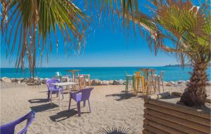 a beach with chairs and tables on the beach at Gorgeous Apartment In Malaga With House Sea View in Málaga