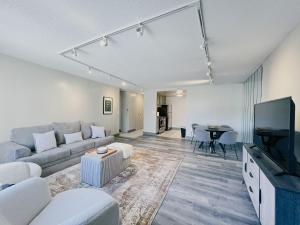 a living room with a couch and a tv and a table at The Hartford Skyline Downtown Hartford XL Center in Hartford