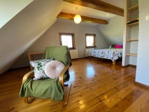 a living room with a chair and a bed at Chata Sikorki 