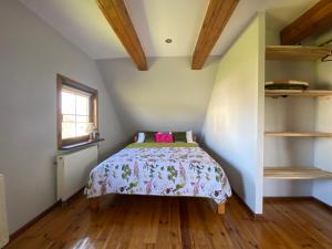 a small bedroom with a bed in a attic at Chata Sikorki in Gorajec