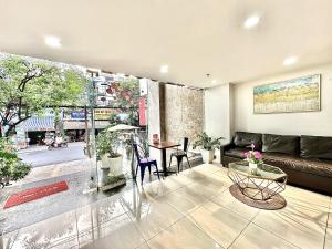 a living room with a couch and a table at The Jade Hotel near Tan Son Nhat Airport in Ho Chi Minh City