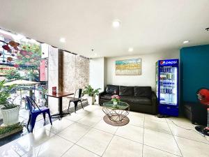 a living room with a couch and a drink machine at The Jade Hotel near Tan Son Nhat Airport in Ho Chi Minh City