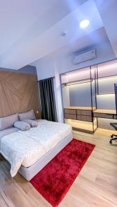 a bedroom with a bed and a red rug at Menara One Hotel by Menara Santosa in Kartosuro
