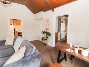 a living room with a couch and a table at The Flat in Carlisle