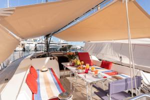 a boat with a table and chairs on a boat at Voilier Luxe Face au Palais in Cannes