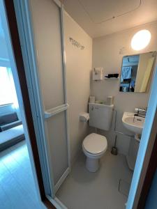 a small bathroom with a toilet and a sink at 新大阪駅徒歩30秒ポケットwifi貸出無料, 30s walk to Shinosaka Station, Umeda 6 mins, Kyoto 25 mins, Early Check in in Osaka
