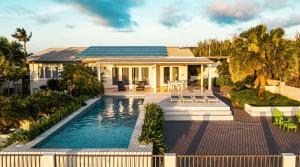 a house with a swimming pool in front of a house at Sombre 14-E in Santa Cruz