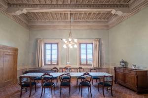a large dining room with a table and chairs at Delcorto Suites in Montepulciano