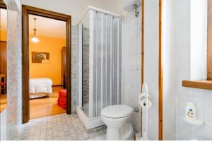 a bathroom with a toilet and a walk in shower at B&B Il Ghiro-Country House in Mormanno