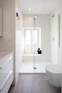 a bathroom with a shower and a toilet and a sink at Ted Surf House in Capbreton