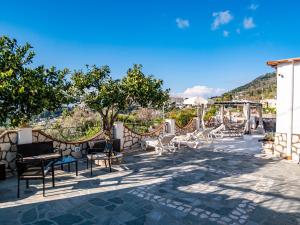 a group of chairs and tables on a patio at Casa Astra in Anacapri