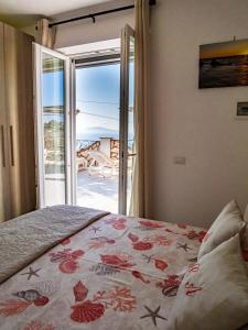 a bedroom with a bed with a view of the ocean at Casa Astra in Anacapri +37 photos