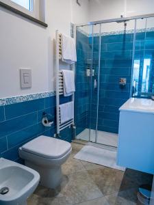 a blue bathroom with a toilet and a shower at Casa Astra in Anacapri +90 photos