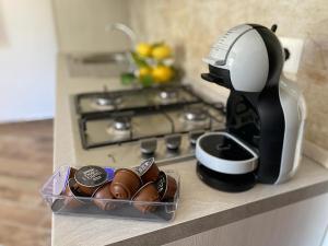 a coffee maker sitting on a counter next to a stove at Le fresie in Cossoine