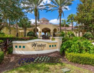 a house with a sign in front of a yard at Fantastic Condo - 2 Miles from Disney Pool View Windsor Hills in Orlando