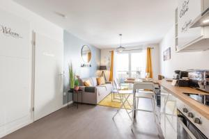 a kitchen and living room with white walls at The Sunshine - BOUB'S in Meaux